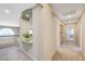 Hallway featuring neutral walls, carpet, display alcove, and access to multiple rooms at 6491 Bright Nimbus Ave, Las Vegas, NV 89139
