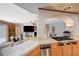 Bright kitchen with stainless steel appliances and tile countertops overlooks the living area at 6491 Bright Nimbus Ave, Las Vegas, NV 89139