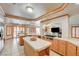 Spacious kitchen features oak cabinets, tile countertops, stainless appliances, and a cozy breakfast nook at 6491 Bright Nimbus Ave, Las Vegas, NV 89139