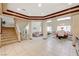 Bright, open-concept living room with staircase, and dining area with large windows at 6491 Bright Nimbus Ave, Las Vegas, NV 89139