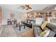Cozy living room with a ceiling fan, tile flooring, and open access to the kitchen and dining area at 6491 Bright Nimbus Ave, Las Vegas, NV 89139