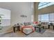 Bright living room features a large sectional sofa, high ceilings and multiple windows at 6491 Bright Nimbus Ave, Las Vegas, NV 89139