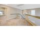 Carpeted loft with glass railing and view of the home's interior at 6491 Bright Nimbus Ave, Las Vegas, NV 89139