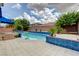 A backyard swimming pool featuring a blue tile trim, palm trees and patio at 6491 Bright Nimbus Ave, Las Vegas, NV 89139