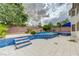 Multi-level pool features blue tile accents, palm trees and a gray tile deck at 6491 Bright Nimbus Ave, Las Vegas, NV 89139