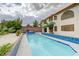 Long, narrow, swimming pool with blue tile accents and palm trees at 6491 Bright Nimbus Ave, Las Vegas, NV 89139