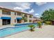 A backyard swimming pool featuring a blue tile trim, palm trees, patio, and views of the home at 6491 Bright Nimbus Ave, Las Vegas, NV 89139