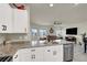 Open-concept kitchen flows into the living area, featuring granite countertops and stainless steel appliances at 7476 Moonglade St, North Las Vegas, NV 89084