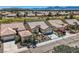 Aerial view of the property showcasing the house's layout, surrounding landscaping, and proximity to a golf course at 7567 Wingspread St, North Las Vegas, NV 89084
