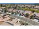 Aerial view of property showcasing homes in a golf community with desert landscaping and well-maintained streets at 7567 Wingspread St, North Las Vegas, NV 89084