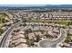 Wide aerial shot of a golf course community with diverse landscaping, offering picturesque views of a desert oasis at 7567 Wingspread St, North Las Vegas, NV 89084