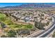 Expansive aerial view of home showcasing its location within a residential community and proximity to a golf course at 7567 Wingspread St, North Las Vegas, NV 89084