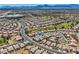 Wide aerial view of a community near a golf course, highlighting neighborhood layout and surrounding landscape at 7567 Wingspread St, North Las Vegas, NV 89084