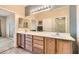 Bathroom featuring double sinks, extensive counter space, tile flooring, and a large mirror at 7567 Wingspread St, North Las Vegas, NV 89084