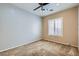 Neutral bedroom featuring a ceiling fan, carpeted floor, and window with white blinds for a bright and airy feel at 7567 Wingspread St, North Las Vegas, NV 89084