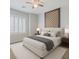 Comfortable bedroom featuring a padded headboard, accent wall, and bedside tables with lamps at 7567 Wingspread St, North Las Vegas, NV 89084