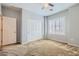 Bedroom with a neutral color palette, ceiling fan, shuttered window and a double door closet at 7567 Wingspread St, North Las Vegas, NV 89084