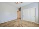 A large bedroom with plush carpeting, a ceiling fan, and a wide closet at 7567 Wingspread St, North Las Vegas, NV 89084