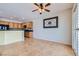 Open concept featuring the dining area with wood cabinets and granite countertops, complemented by a ceiling fan and sliding doors at 7567 Wingspread St, North Las Vegas, NV 89084