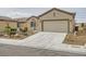 Charming single-story home featuring a well-manicured front yard and a two-car garage at 7567 Wingspread St, North Las Vegas, NV 89084