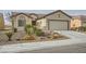 Charming single-story home featuring desert landscaping, a tile roof, and a two-car garage at 7567 Wingspread St, North Las Vegas, NV 89084