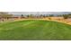 Expansive green golf course with well-manicured grounds and homes in the background under a cloudy sky at 7567 Wingspread St, North Las Vegas, NV 89084