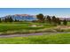 Beautiful green golf course with mountain backdrop, showcasing the community's desirable location and amenities at 7567 Wingspread St, North Las Vegas, NV 89084