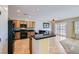 Well-lit kitchen featuring a black appliance package, breakfast bar, and tile flooring at 7567 Wingspread St, North Las Vegas, NV 89084