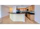 An open kitchen featuring wood cabinets, granite countertops, tile backsplash, and black appliances at 7567 Wingspread St, North Las Vegas, NV 89084