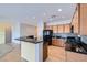 An open kitchen featuring wood cabinets, granite countertops, tile backsplash, and stainless steel appliances at 7567 Wingspread St, North Las Vegas, NV 89084