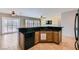 Kitchen with tile floors, breakfast bar, oak cabinets, and black appliances package at 7567 Wingspread St, North Las Vegas, NV 89084