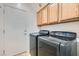 Functional laundry room with cabinetry, washer, and dryer at 7567 Wingspread St, North Las Vegas, NV 89084