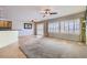 Open living room with neutral tones, bright windows with blinds, carpet, and tile flooring at 7567 Wingspread St, North Las Vegas, NV 89084