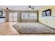 Spacious open living room with tile flooring, ceiling fan, and lots of natural light from windows and sliding doors at 7567 Wingspread St, North Las Vegas, NV 89084