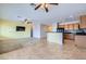Open-concept layout with the kitchen seamlessly connected to the living area with tile flooring and natural light at 7567 Wingspread St, North Las Vegas, NV 89084