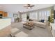 Staged living room with sofa, dining table, area rug, tile flooring, and lots of natural light at 7567 Wingspread St, North Las Vegas, NV 89084