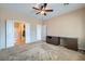 Large main bedroom with ceiling fan and an open doorway to an ensuite bathroom at 7567 Wingspread St, North Las Vegas, NV 89084