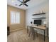 Bright office space featuring a ceiling fan, floating shelves, and a modern desk setup at 7567 Wingspread St, North Las Vegas, NV 89084