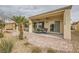 Inviting covered patio with brick pavers, ceiling fan, and view of desert landscaping at 7567 Wingspread St, North Las Vegas, NV 89084