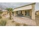 Charming covered patio with outdoor seating, sliding glass doors, and beautiful landscaping at 7567 Wingspread St, North Las Vegas, NV 89084