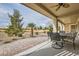 Charming covered patio with outdoor seating and views of the well-maintained landscape at 7567 Wingspread St, North Las Vegas, NV 89084