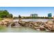 Beautiful community pond with rock waterfall feature and abundant birdlife in a serene setting at 7567 Wingspread St, North Las Vegas, NV 89084