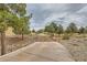 Picturesque walking path lined with trees and rocks under a cloudy sky at 7567 Wingspread St, North Las Vegas, NV 89084