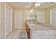 Bright bathroom features a granite countertop vanity with double sinks and decorative lighting at 7581 Slipstream St, Las Vegas, NV 89139