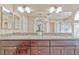 Bathroom with double sinks, dark wood cabinets, granite countertop, and decorative lighting at 7581 Slipstream St, Las Vegas, NV 89139
