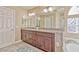 Bathroom vanity with granite counters, dual sinks, and decorative floral arrangement at 7581 Slipstream St, Las Vegas, NV 89139