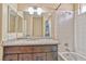 Bathroom featuring a granite countertop, vanity, and tiled shower-tub combo at 7581 Slipstream St, Las Vegas, NV 89139