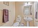 Powder room features pedestal sink, framed mirror, and neutral decor at 7581 Slipstream St, Las Vegas, NV 89139
