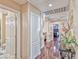 Bright hallway featuring hardwood floors, storage cabinets, and access to various rooms at 7581 Slipstream St, Las Vegas, NV 89139