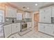 A well-lit kitchen featuring granite countertops, stainless steel appliances, and adjacent laundry room at 7581 Slipstream St, Las Vegas, NV 89139